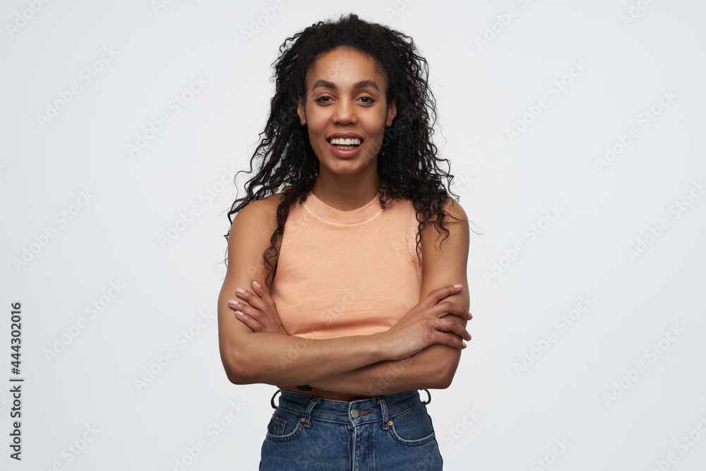 indoor shot of young african american female standing over white background, looking at camera with a broadly smile. indoor shot of young african american female standing over white background, looking at camera with a broadly smile.