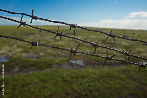 Remains of an artillery battery fencing in the tundra, Murmansk region of Russia.