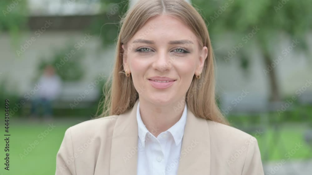Outdoor Portrait of Thumbs Down Gesture by Young Businesswoman Outdoor Portrait of Thumbs Down Gesture by Young Businesswoman