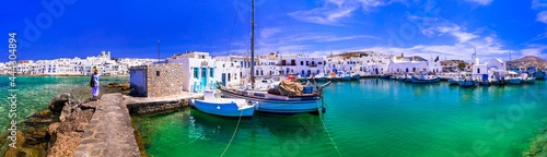 Greece travel. Cyclades  Paros island. Charming fishing village Naousa. view of old port with  boats and street taverns by the sea.