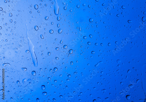 Rain drops on the glass blue color for texture and background