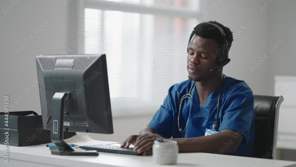 Doctor's Online Medical Consultation: African American Physician Making a Conference Video Call with a Patient on a Desktop Computer. Doctor's Online Medical Consultation: African American Physician Making a Conference Video Call with a Patient on a Desktop Computer.