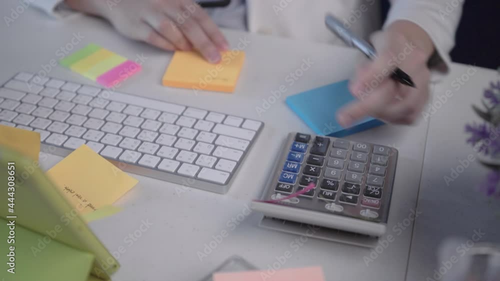 salary employee working at her desk in the office during office hours. salary employee working at her desk in the office during office hours.