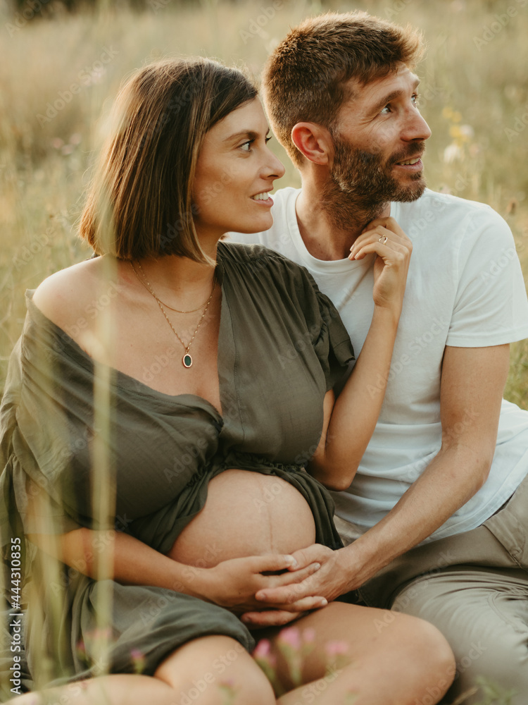 Man embracing pregnant woman in nature Man embracing pregnant woman in nature