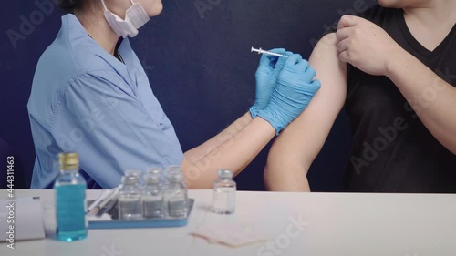 Doctors vaccinate people against COVID-19 who received treatment