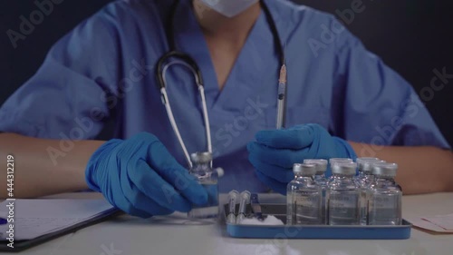 Female doctor preparing coronavirus vaccine for public injection service