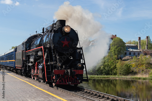 Fototapeta Naklejka Na Ścianę i Meble -  a black retro steam locomotive close up