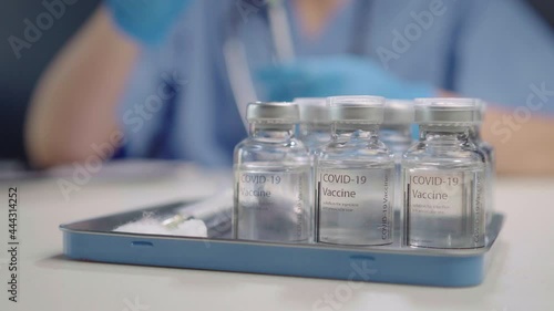 Female doctor preparing coronavirus vaccine for public injection service
