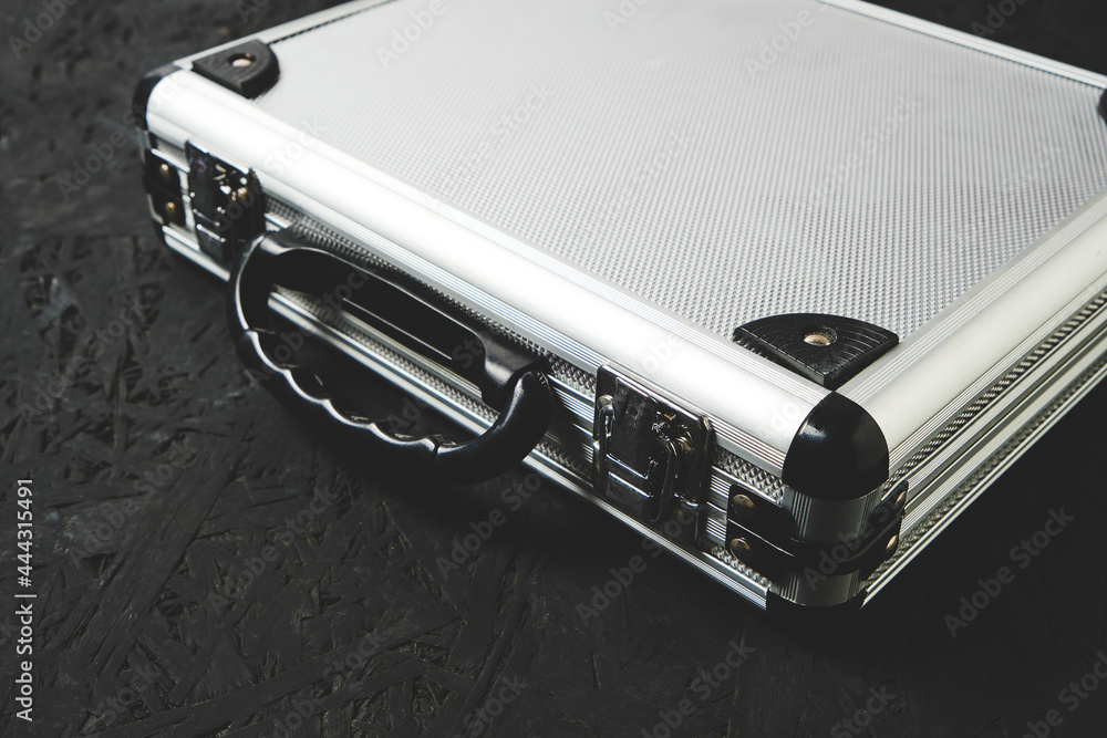 Metal aluminum briefcase on a black background. Metal aluminum briefcase on a black background.