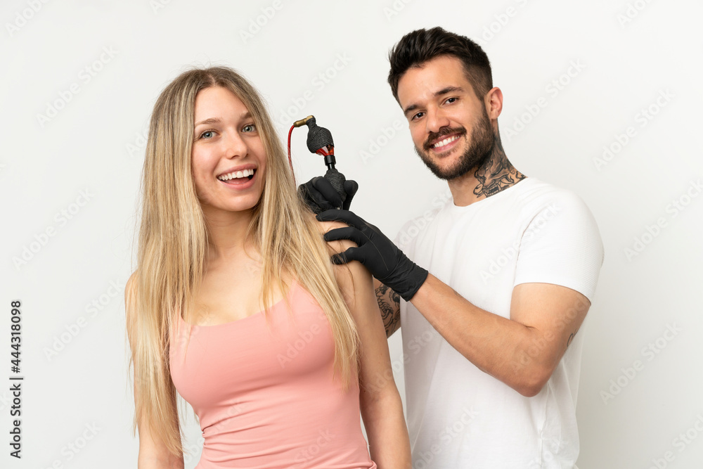 man tattooing a girl over isolated background man tattooing a girl over isolated background