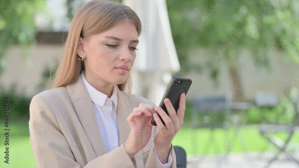 Outdoor Young Businesswoman Browsing internet on Smartphone, Text Messaging Outdoor Young Businesswoman Browsing internet on Smartphone, Text Messaging
