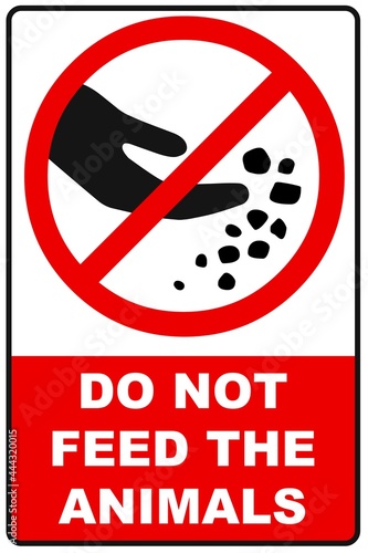Warning sign with the text forbidding to feed animals. Do not feed animals. Red prohibition sign, black silhouette of hand and food. Simple image isolated on white background. 