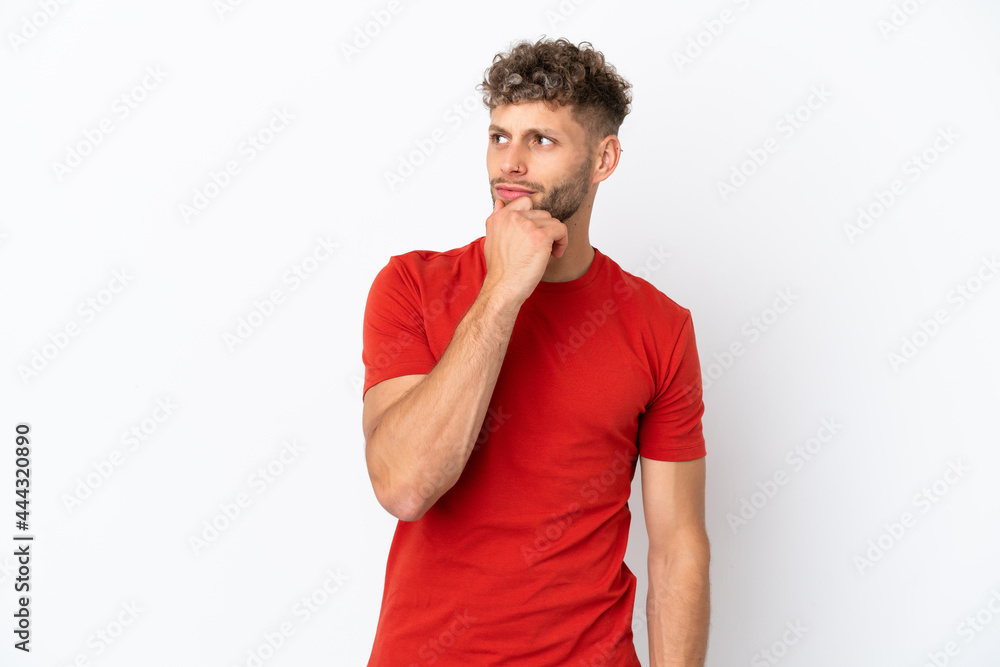 Young caucasian handsome man isolated on white background and looking up Young caucasian handsome man isolated on white background and looking up