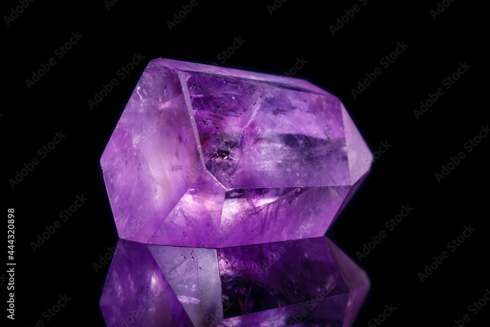 Macro mineral stone Amethyst crystal on a black background Macro mineral stone Amethyst crystal on a black background