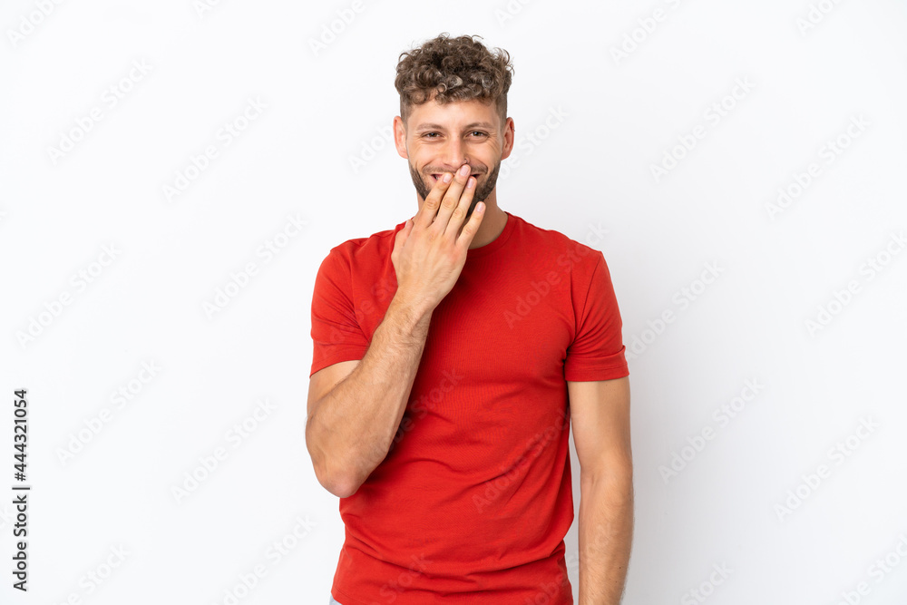 Young caucasian handsome man isolated on white background happy and smiling covering mouth with hand Young caucasian handsome man isolated on white background happy and smiling covering mouth with hand