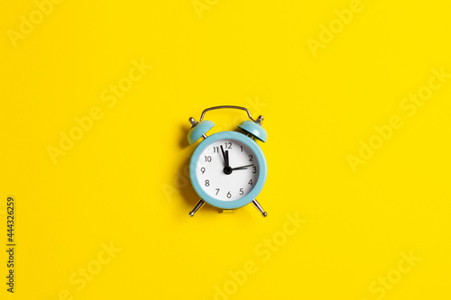 Blue vintage clock on yellow background in honor of Ukrainian Independence Day