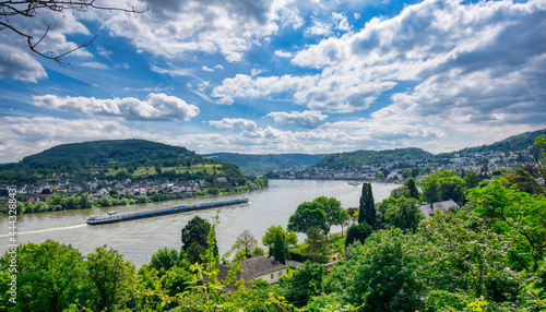 Ship on Mosel River under puffy clouds and blue sky
