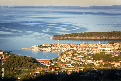 First morning light hits the village of rab in croatia photo