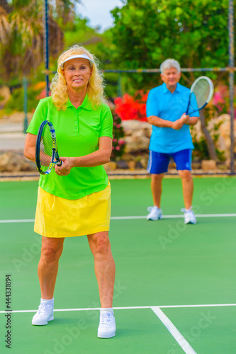 Senior couple playing tennis on sunny day. © TRAVEL EASY