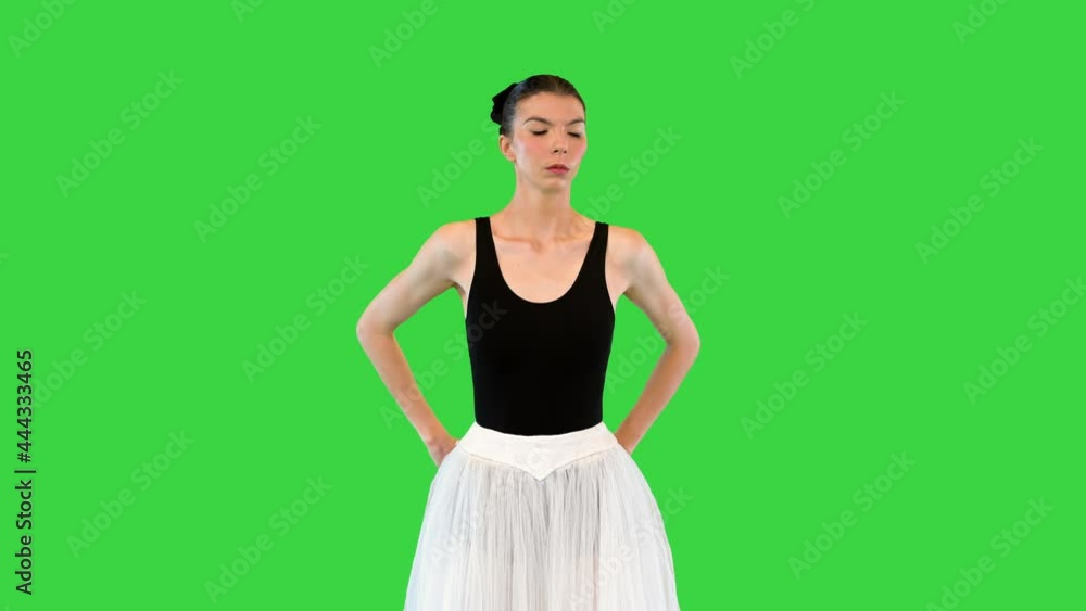 Young ballerina warming up shoulder joints on a Green Screen, Chroma Key. Young ballerina warming up shoulder joints on a Green Screen, Chroma Key.