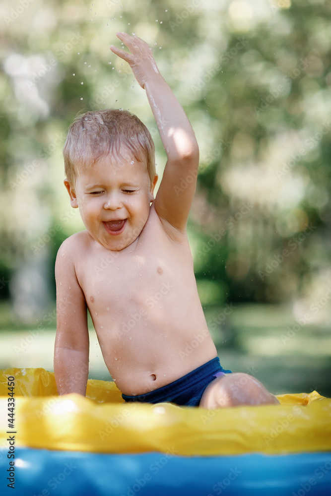 Child splashing in the pool in hot summer day Child splashing in the pool in hot summer day
