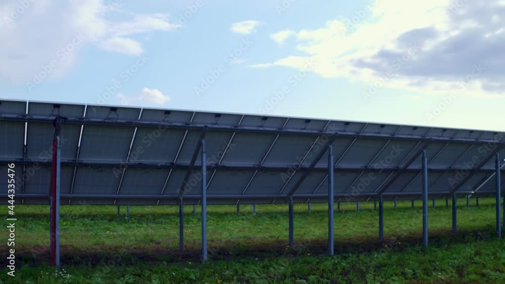 View from behind on electrical modules at a solar power plant. Installation of autonomous hybrid power devices in remote areas. Renewable energy. High quality. 4k footage. View from behind on electrical modules at a solar power plant. Installation of autonomous hybrid power devices in remote areas. Renewable energy. High quality. 4k footage.