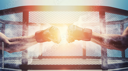 Mma fight, close up of two fists hitting each other over dark, dramatic sky with copy space.
