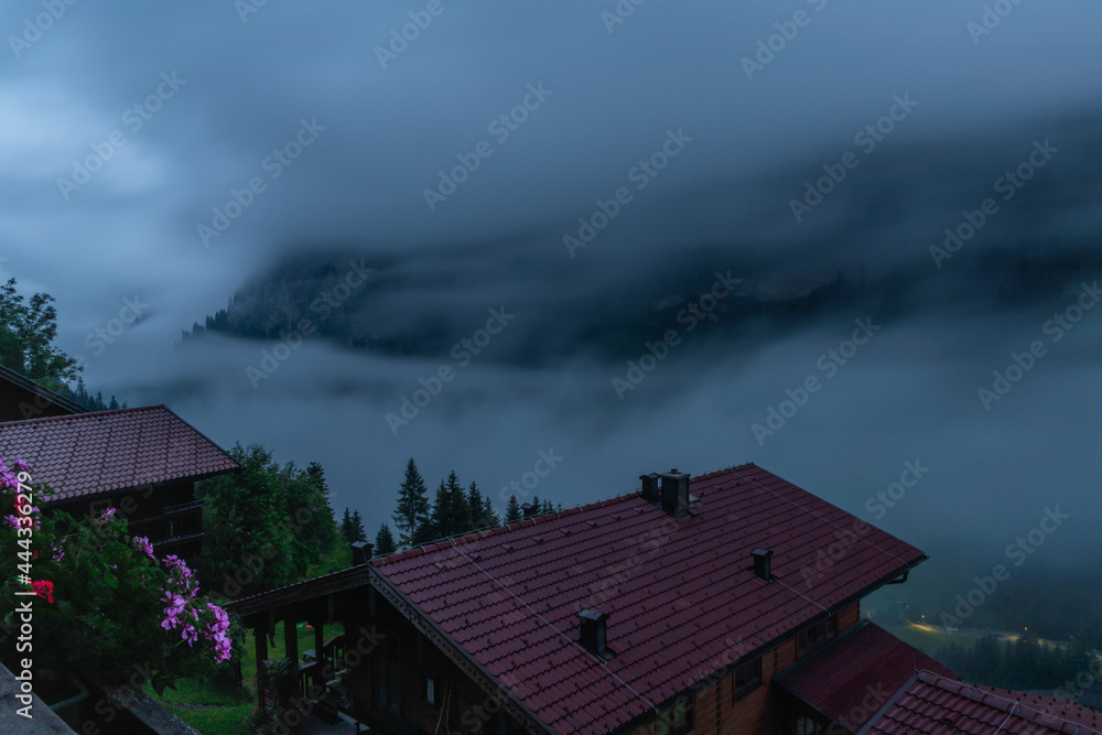Summer valley morning with fog with Grossarler Ache river and blue cloudy sky