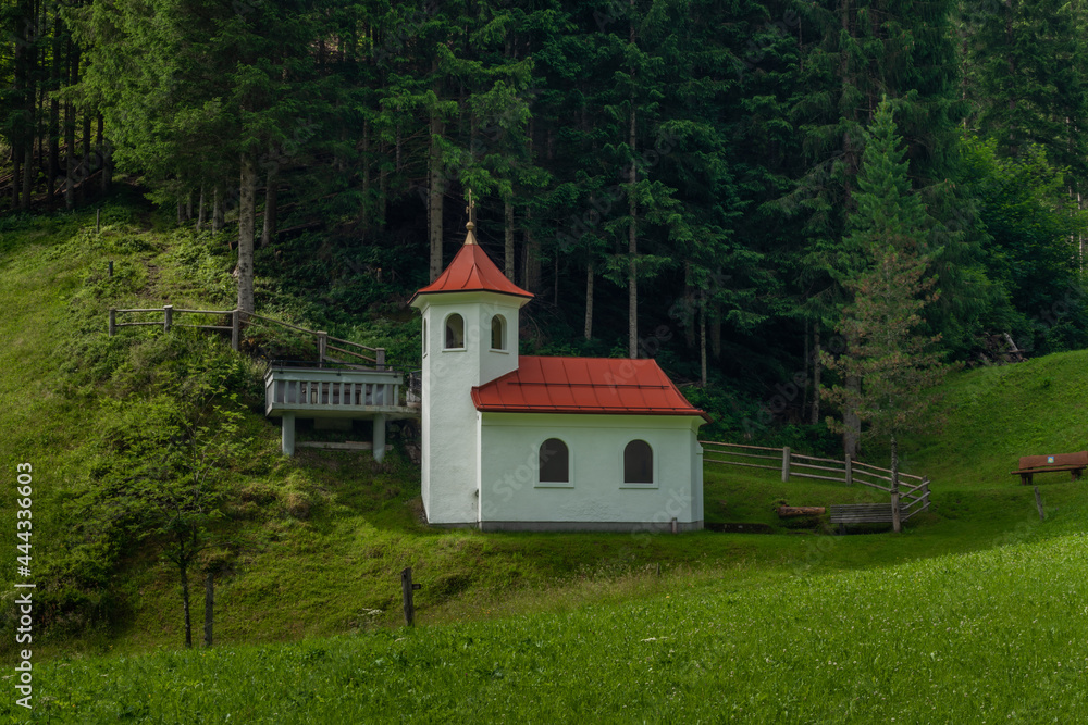 Wolfaukapelle chapel in sunny cloudy morning in Austria mountains