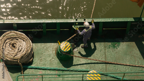 One seaman watching the mooring line during mooring of cargo ship photo
