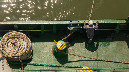One seaman watching the mooring line during mooring of cargo ship