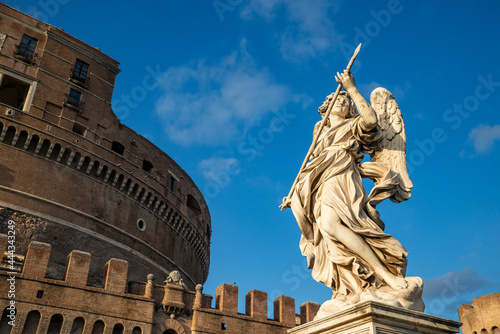 Angel with the spear of the Bernini school with the Castel Sant'Angelo, Vatican, from the Ponte degli Angeli over the Tiber, with a clear blue sky after a thunderstorm, Vatican, Rome, Italy.