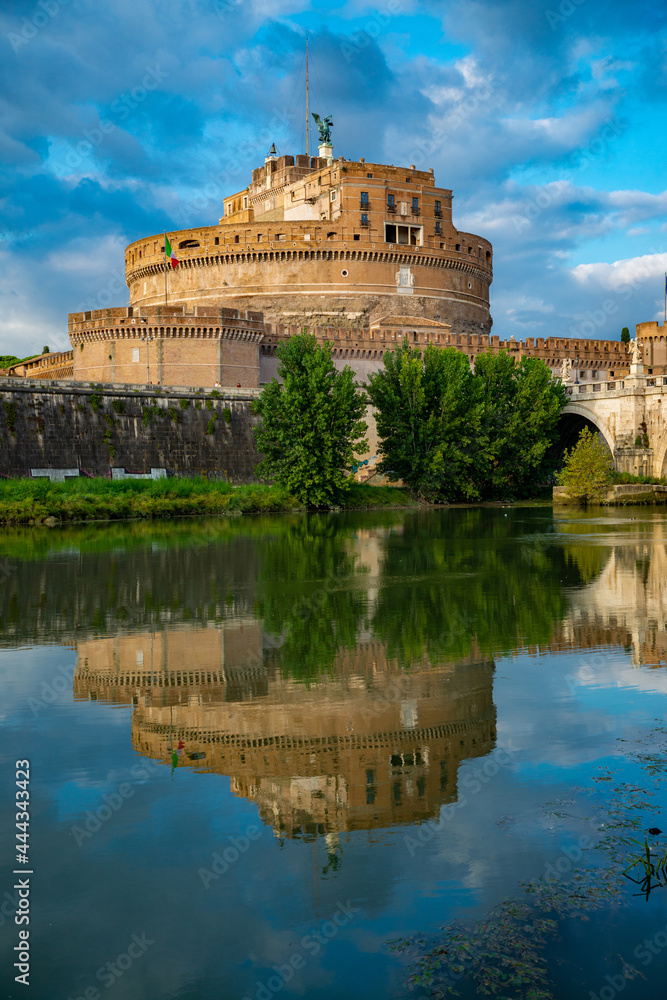 Castel Sant'Angelo, or Mausoleum of Hadrian, located near the Vatican, while it is reflected in the Tiber with the bridge of the Angels, on an autumn day. Vatican, Rome, Italy.