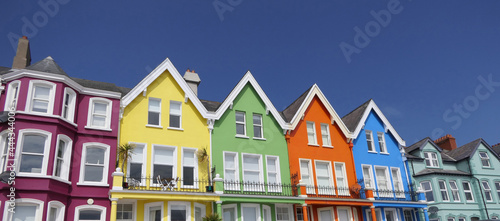 Fototapeta Naklejka Na Ścianę i Meble -  Yellow Red Orange Green Blue sky houses by the sea Whitehead N. Ireland