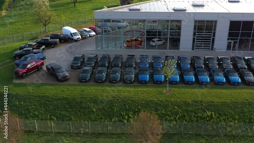 Aerial view of storage parking with new unsold cars. Cars dealership inventory distribution automobile and automotive business.