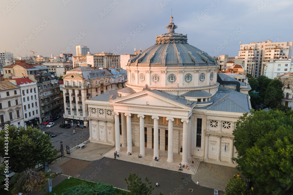 Aerial drone view of The Romanian Athenaeum George Enescu (Ateneul Roman) in Bucharest, Romania. Most prestigious concert hall and one of the most beautiful buildings in the city in the sunset.