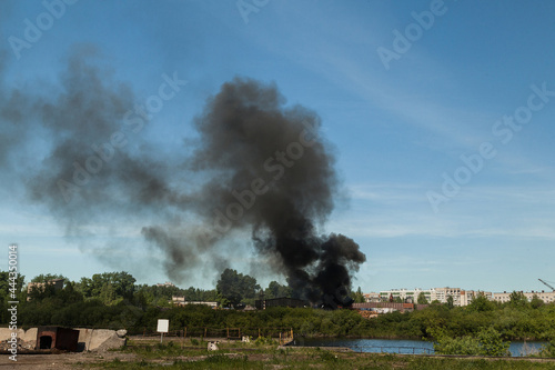 A sawmill fire with a huge column of black smoke