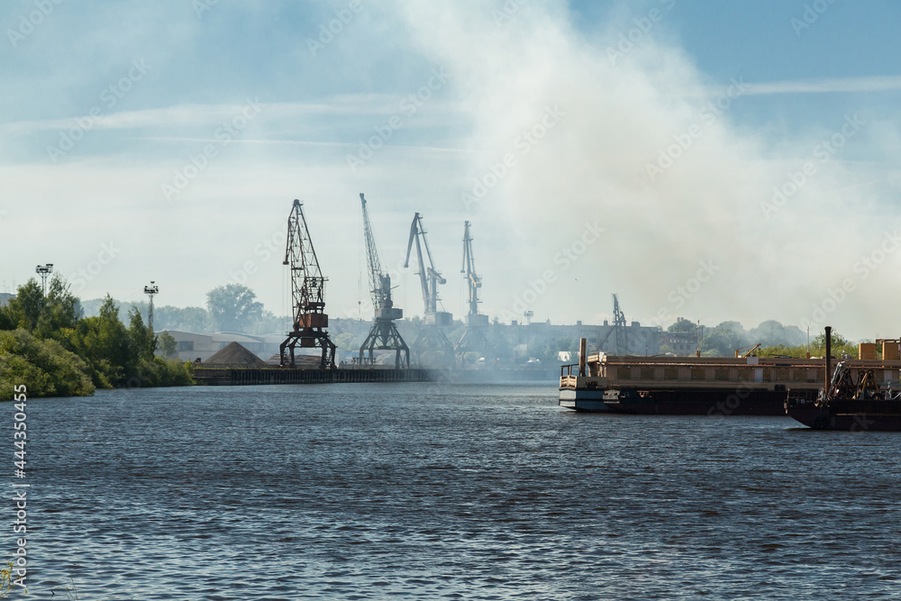 Small river port with industrial cranes