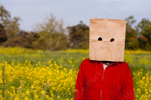 Bag head standing in a field