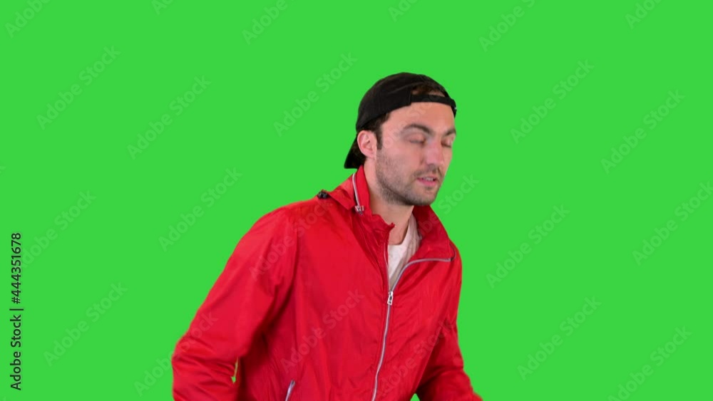 Young man running in a windbreaker on a Green Screen, Chroma Key. Young man running in a windbreaker on a Green Screen, Chroma Key.