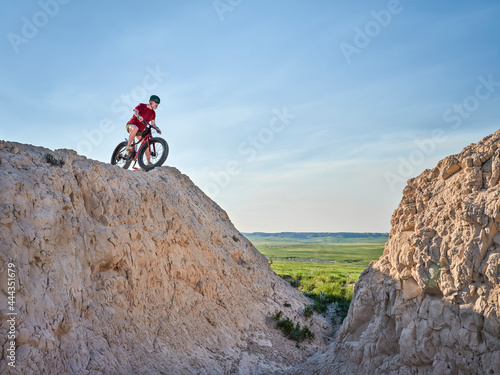 Senior man is riding a fat mountain bike in badlands of Pawnee National Grassland in northern Colorado