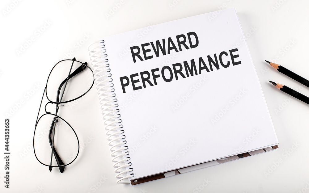 Notepad with text REWARD PERFORMANCE . White background. Business concept Notepad with text REWARD PERFORMANCE . White background. Business concept