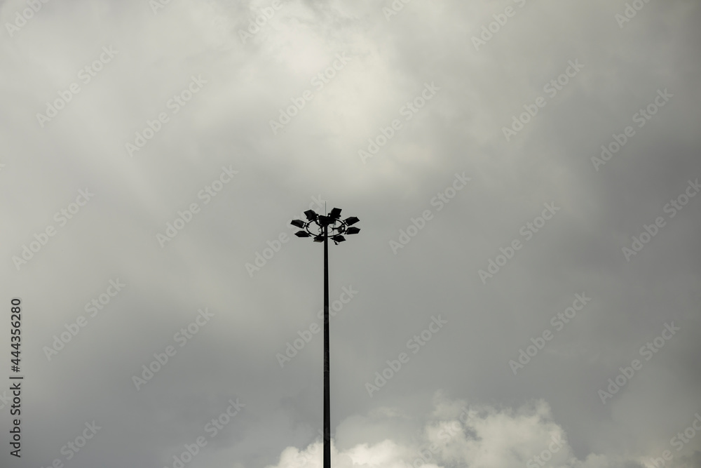 A fan pole against a grey sky.