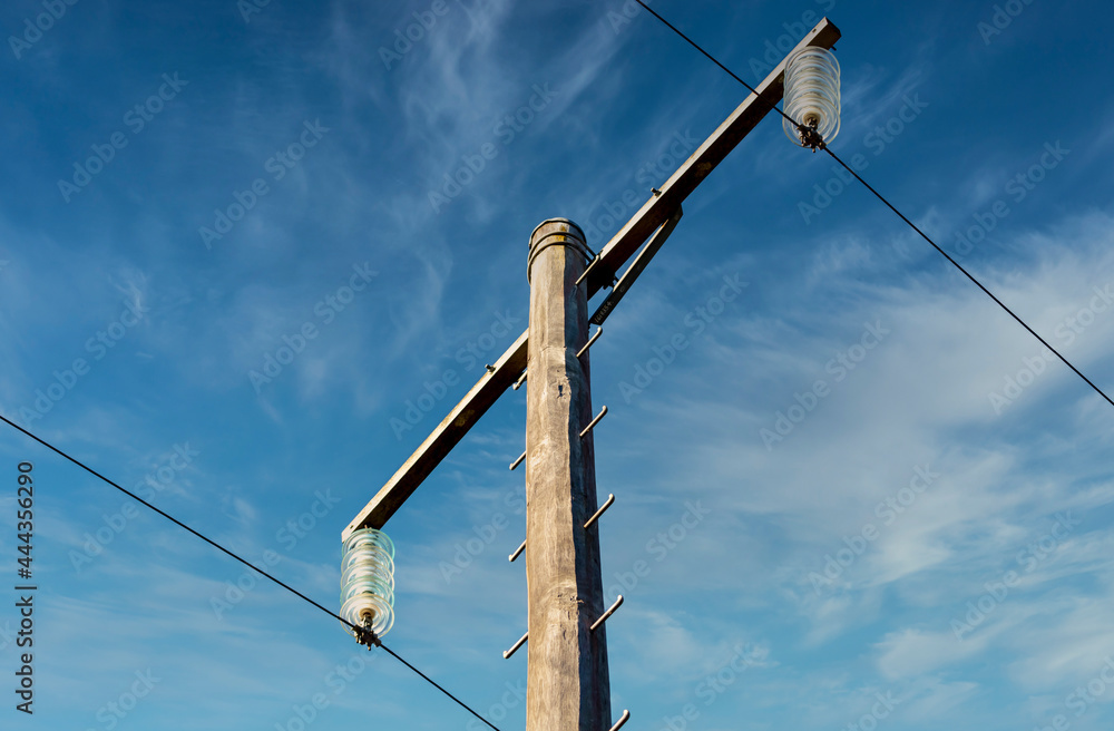 Photograph of a wooden telephone post and cables