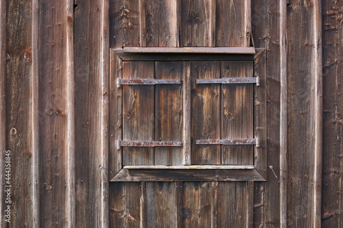 geschlossene Fensterläden an einer alten Scheune, alles ist aus Holz photo