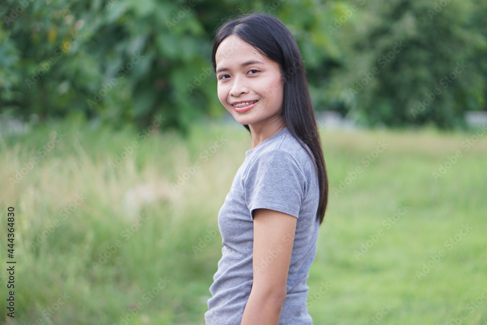 Asian woman is walking happily in the middle of the meadow. Asian woman is walking happily in the middle of the meadow.