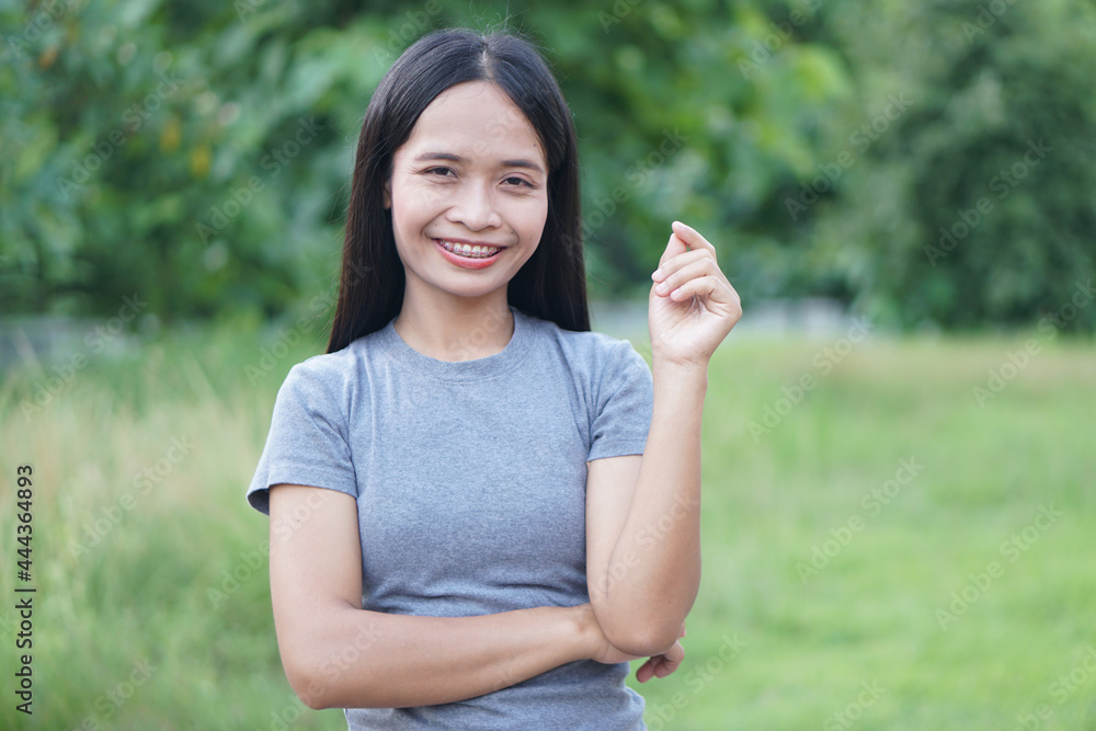 Asian woman is walking happily in the middle of the meadow. Asian woman is walking happily in the middle of the meadow.