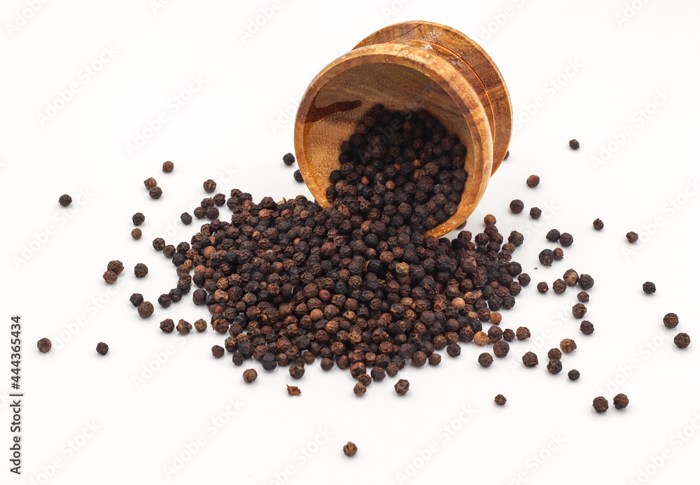 black pepper in a wooden bowl isolated on white background black pepper in a wooden bowl isolated on white background