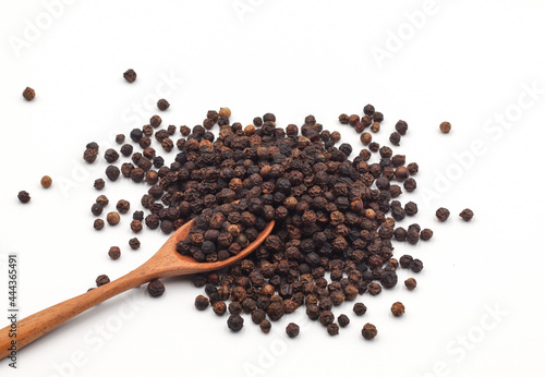 black pepper in a wooden bowl isolated on white background