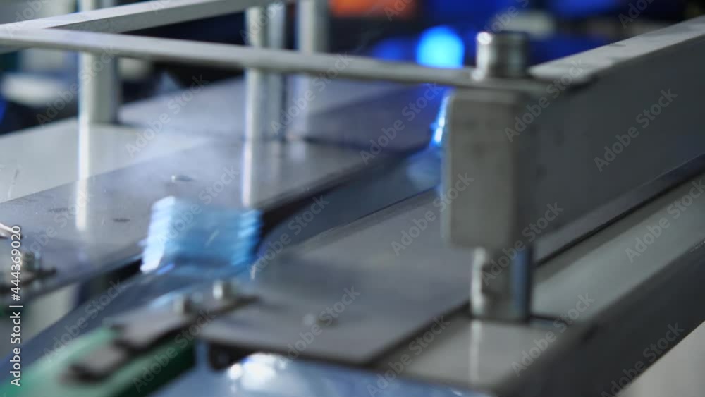 Close-up of freshly blown bottles coming out of the vending machine. Plant for the production of drinking and mineral water Close-up of freshly blown bottles coming out of the vending machine. Plant for the production of drinking and mineral water